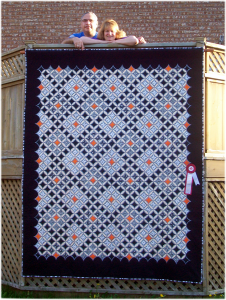 Ariana and Luis with their cathedral window quilt